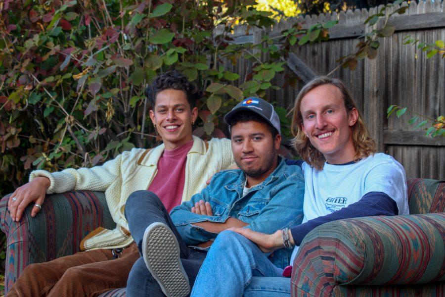 Lady Denim band members (left to right) lead guitarist Nic Lubin, drummer and percussionist Matthias Mandl, and lead vocalist and guitarist Nick Lundeen sit outside in their backyard Oct. 14. (Megan McGregor | Collegian)