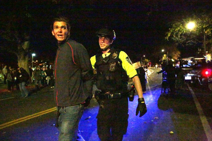 A protester is led away from the crowd by a police officer at the Charlie Kirk Culture War event at the University Center for the Arts Oct. 22, 2019. The event featured both Charlie Kirk, a prominent conservative speaker, and Donald Trump Jr., where they discussed conservative values and socialism in the U.S. (Forrest Czarnecki | The Collegian)
