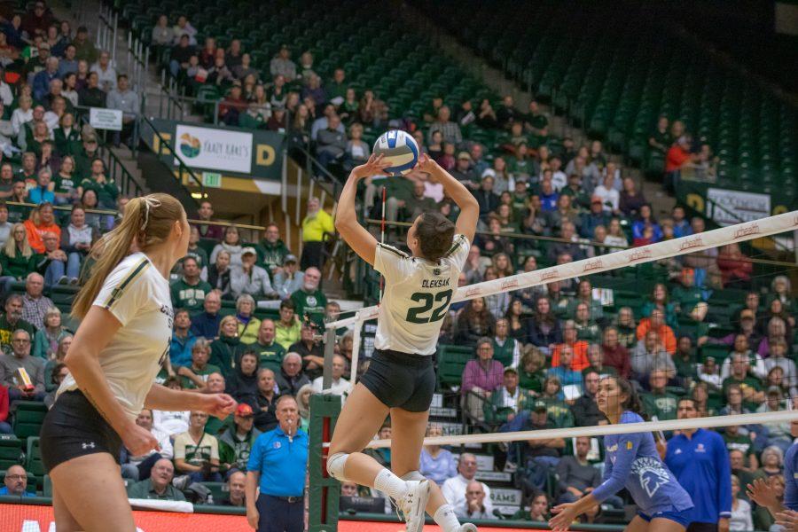 Kirstie Hillyer(#13) runs towards the net as Katie Oleksak(#22) sets the ball into the air, during a University home game against San Jose State. CSU wins three sets to zero. (Devin Cornelius | Collegian)