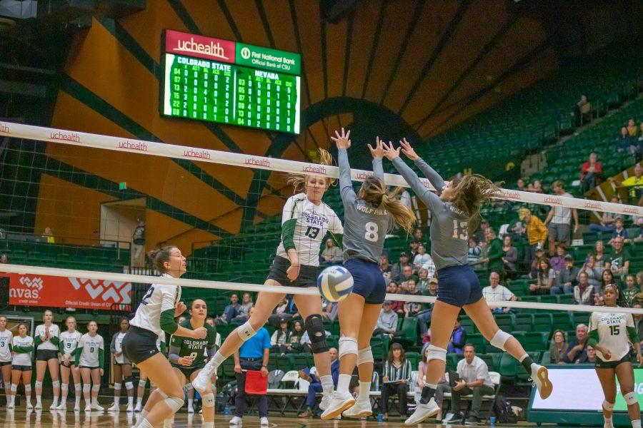 Kirstie Hillyer(#13) spikes the ball down on the Nevada side, as the University takes on Nevada at home. CSU wins three sets to zero. (Devin Cornelius | Collegian)