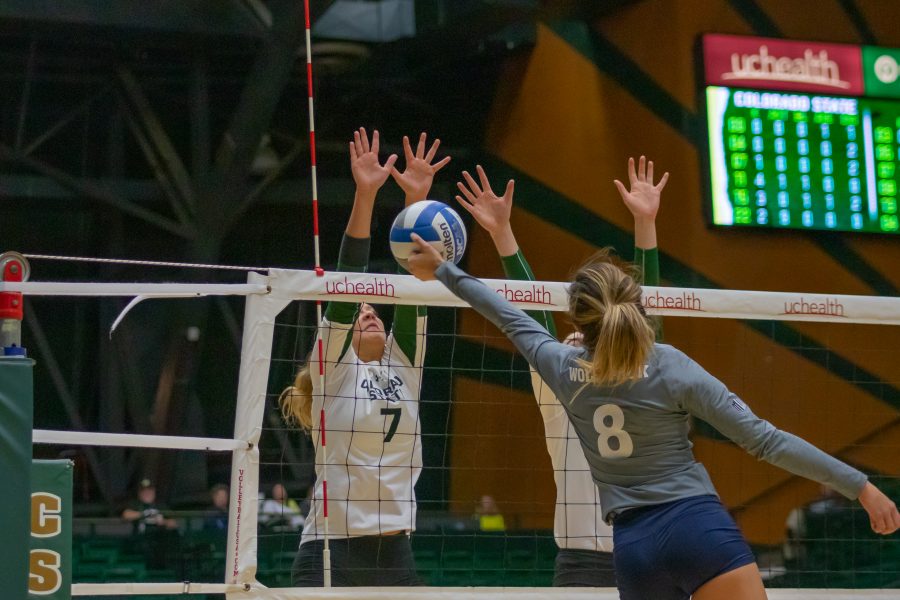 Sasha Colombo (7) jumps up and blocks the tip attempt from a Nevada player, during the University home game against Nevada. CSU wins three sets to zero.(Devin Cornelius | Collegian)