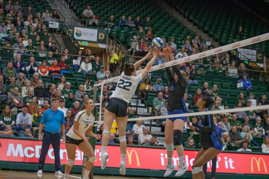 Katie Oleksak (22) pushes the ball down towards her opponents side, during the University's home game against Air Force. CSU wins three sets to zero. (Devin Cornelius | Collegian)