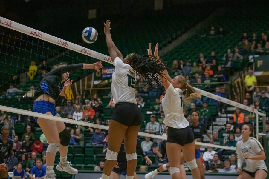 Breana Runnels (15) and Sasha Colombo (7) jump up and attempt to block an incoming spike, during the University's  home game against Air Force. CSU wins three sets to zero. (Devin Cornelius | Collegian)