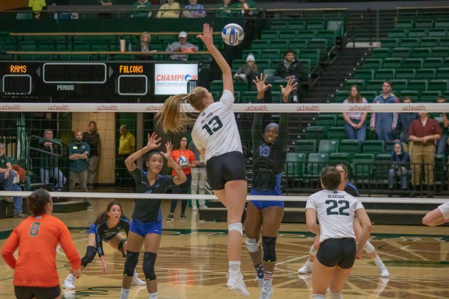 Kirstie Hillyer (13) spikes the ball down on her Opponent's side, during the University's Home game against Air Force. CSU wins three sets to zero. (Devin Cornelius | Collegian)