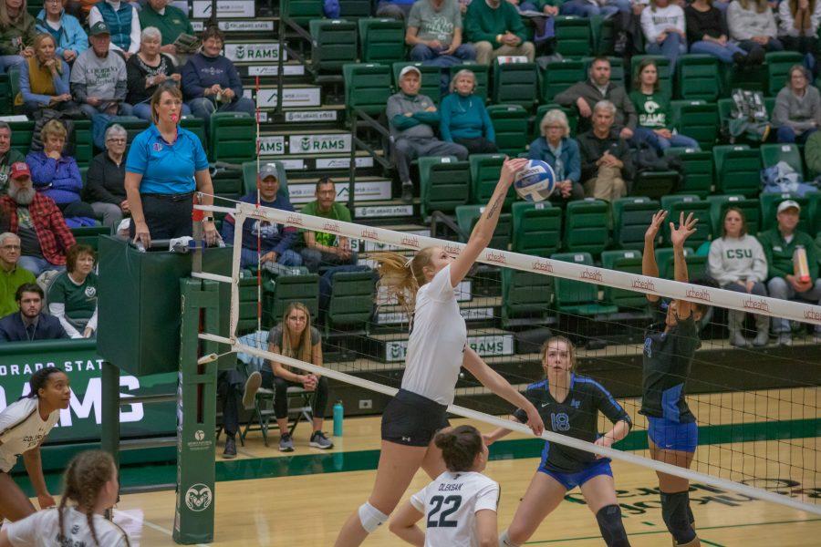 Kirstie Hillyer (13) spikes the ball down on her Opponent's side, during the University's Home game against Air Force. CSU wins three sets to zero. (Devin Cornelius | Collegian)
