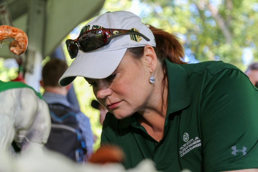 Baker Janet Barron places cupcakes on display for the Walter Scott, Jr. College of Engineering during the Festival on the Oval Friday, Oct. 4th. Barron handmade 1,000 cupcakes and a ram sculpted out of chocolate for the homecoming event. (Brooke Buchan | Collegian)