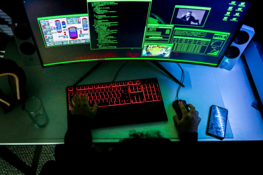 Man coding on computer. (Photo Illustration by Brooke Buchan | The Collegian) 