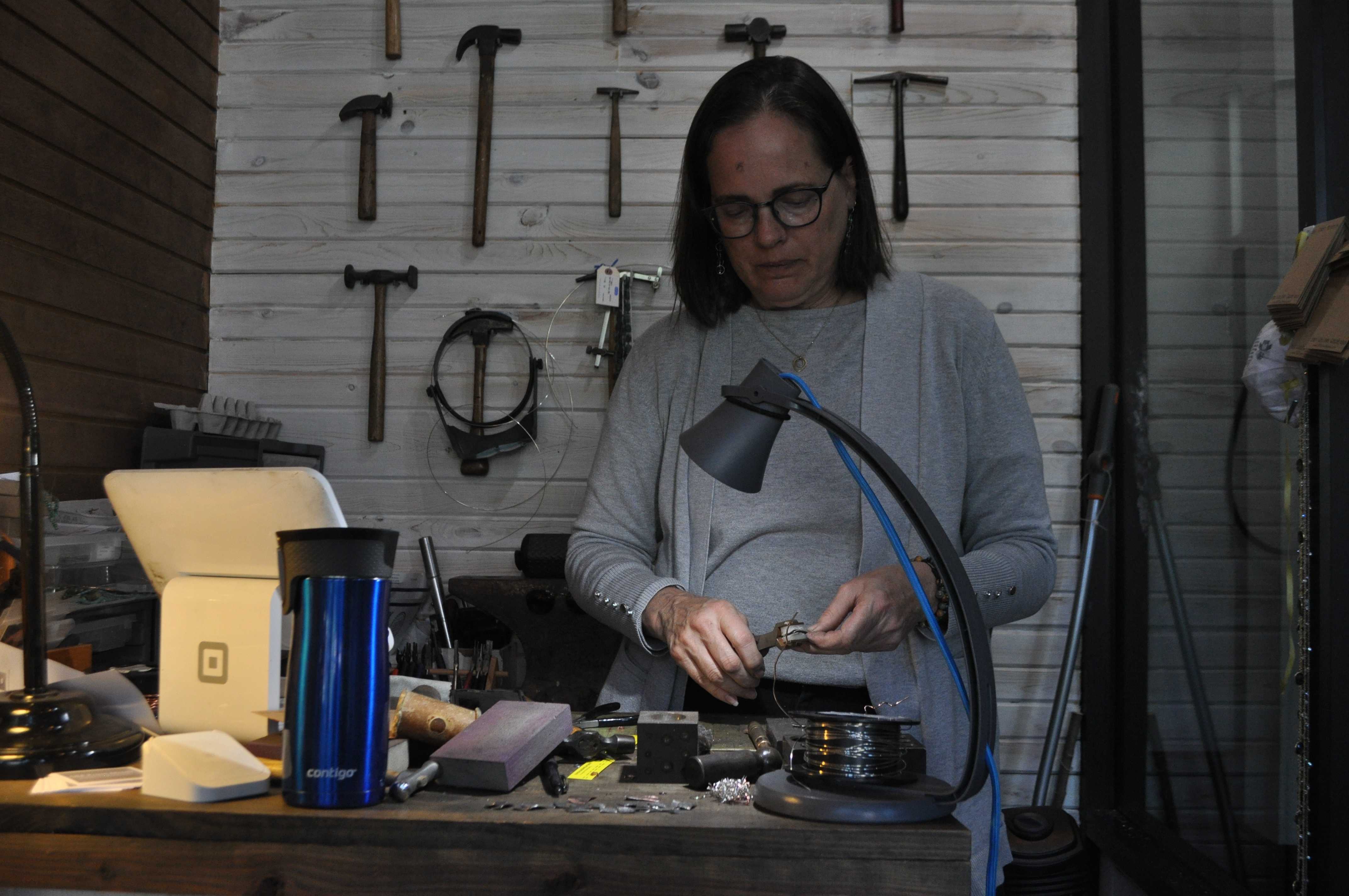 Woman making jewelry at worktable
