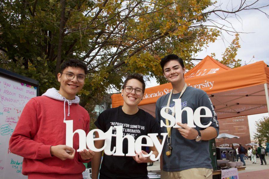 Rafael Duarte, Maggie Hendrickson and Liv Chapman hold up their pronouns for International Pronouns Day in front of the Lory Student Center Oct. 16. Duarte said that “we wanted to make sure people are aware that there’s different pronouns other than the binary and just to respect them and embrace them.” (Ryan Schmidt | The Collegian)