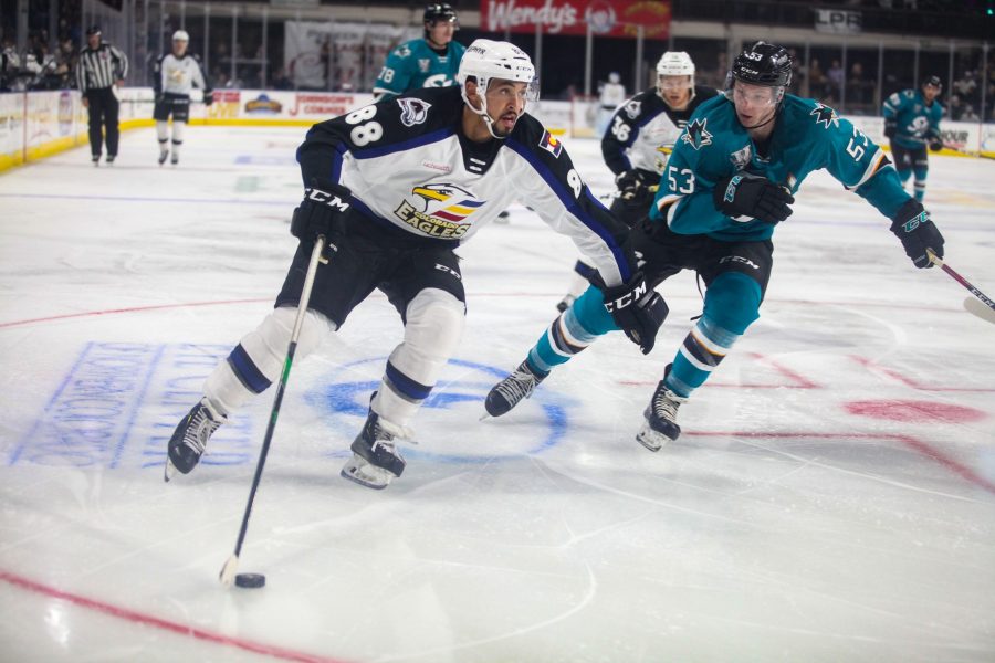 Eagles forward Michael Joly skates the puck around the face-off circle during a game against the San Jose Barracuda on 10/26. (Photo courtesy of the Colorado Eagles). 