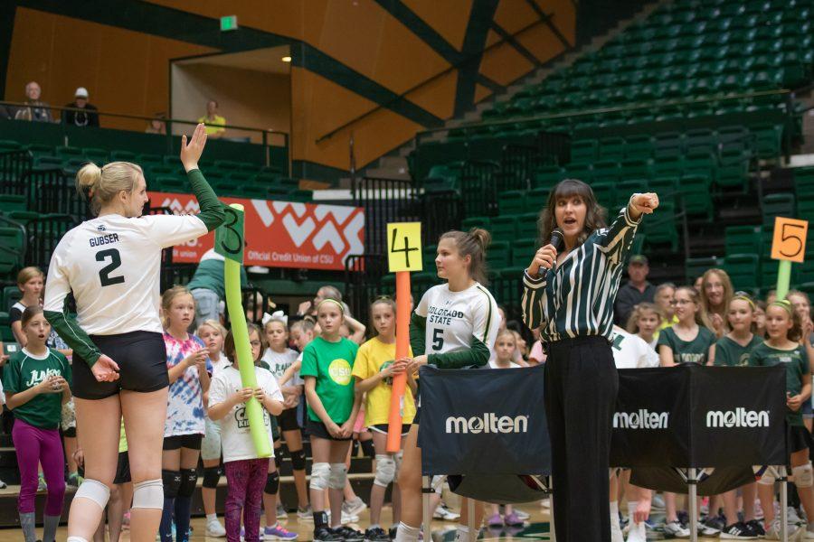 Ellie Gubser raises her hand as Emily Kohan the associate head coach tells the children where all the stations are an what they will be doing, during the Clinic on Oct. 26 at Moby Arena. (Devin Cornelius | Collegian)