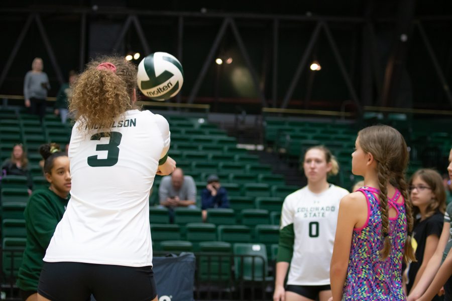 Olivia Nicholson shows the children at Ram's Volleyball Clinic how to bump the ball properly on Oct. 26 at Moby Arena.  (Devin Cornelius | Collegian)