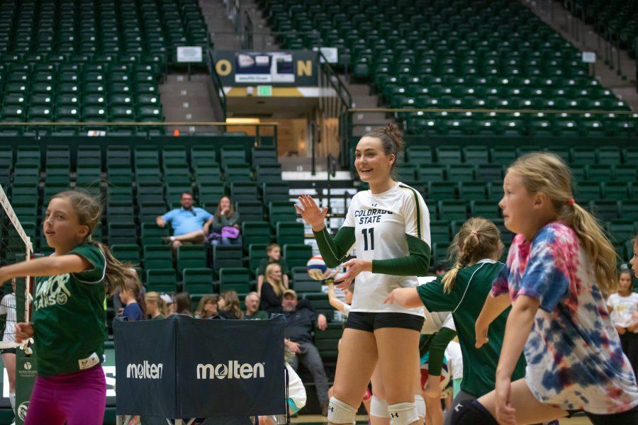 Paulina Hougaard-Jensen Smiles while teaching children how to serve during a Rams Volleyball Clinic. On Oct.26 at Moby. (Devin Cornelius | Collegian)