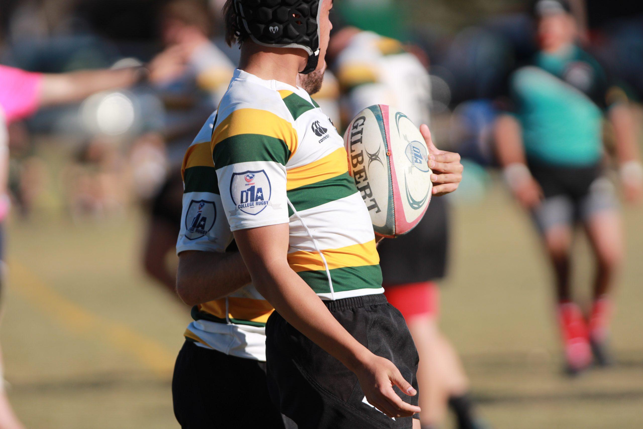 a person standing with a rugby ball