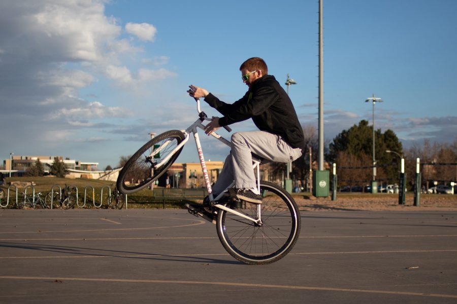 Fifth year Chemical and Biological Engineering student Austin Reed spends some time practicing his BMX tricks with his friend Alonso Preciado on the sunny afternoon of November 13th. He picked up the hobby 3 years ago. In this photo he practices a trick called a wheely bar spin. I like to ride BMX to stay in shape and take my mind of the daily struggle, said Reed. (Addie Kuettner | The Collegian)