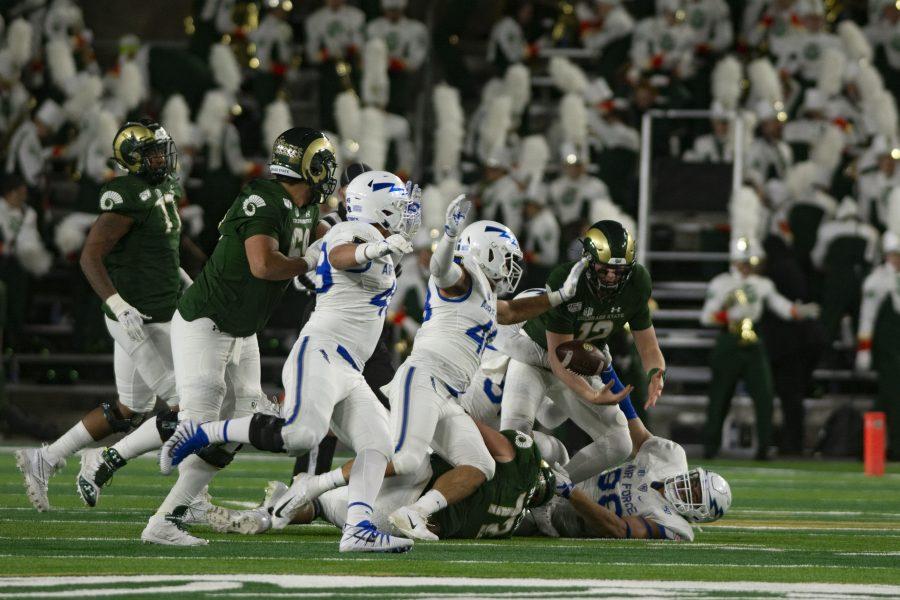 Colorado State university Patrick O’ Brien (12) fumbles the ball after scrambling forward for a first down