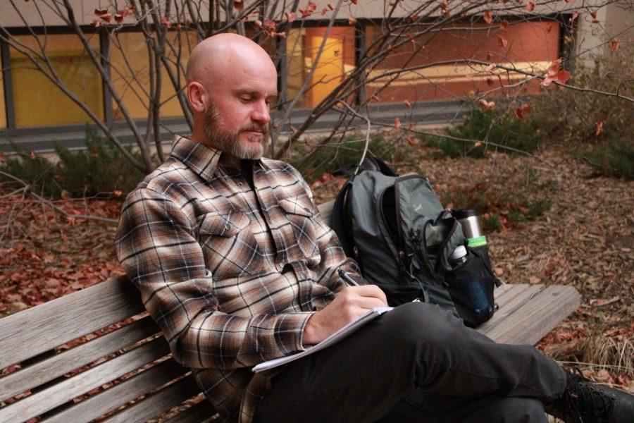 U.S. Army Veteran and Second-Year Masters of Fine Arts student Ryan Lanham writes while sitting on a bench Nov. 20. Lanham is in the Department of English at Colorado State University and is facilitator of the University Writing Center’s Veterans Writing Workshop. Lanham got his undergraduate in History with a minor in creative writing and says something that comes to his mind often is  Think of yourself, question authority. (Asia Kalcevic | The Collegian) 