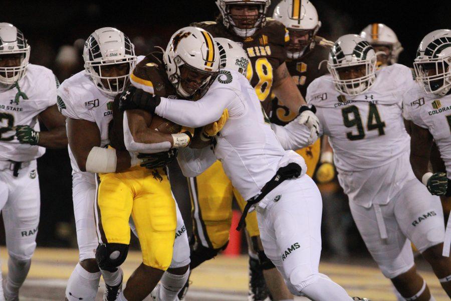 Colorado State University Rams push together against the University of Wyoming Cowboys to stop the ball from traveling down the field any farther at War Memorial Stadium Nov. 22, 2019. (Asia Kalcevic | The Collegian) 