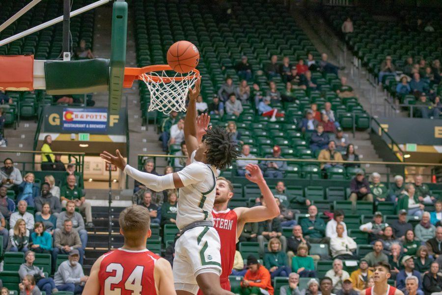 P.J. Byrd (5) shoots a layup after moving around defenders, during the University exhibition match against Western Colorado. CSU wins 79-41. (Devin Cornelius | Collegian)