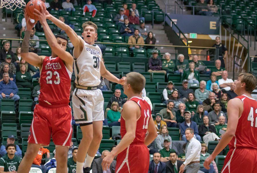 Adam Thistlewood (31) knocks the ball out of a defender's hand, during the University's exhibition match against Western Colorado.(Devin Cornelius | Collegian)