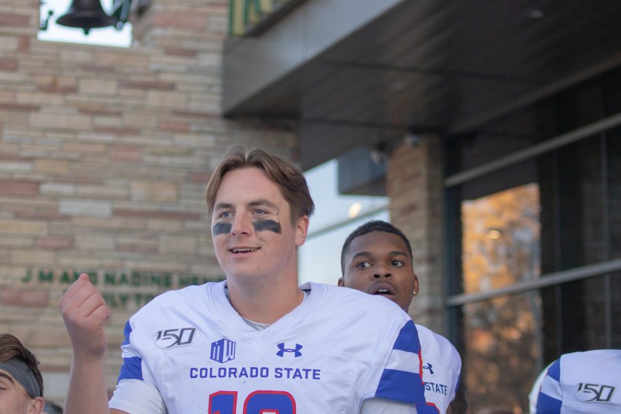 Patrick O'Brien (12) asks if anyone has the key so that they can ring the Old Main bell, after the University beat the University of Las Vegas at home. CSU won 37-17. (Devin Cornelius | Collegian)