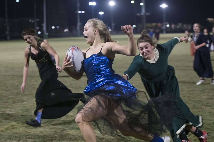 Colorado State University womens rugby player Emily Jagerhorn runs down the sideline while player Ruby Charney tries to tackle her from behind Nov. 8. (Lucy Morantz | The Collegian)