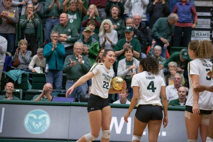 Katie Oleksak (22) Celebrates with her teammates after breaking the CSU all time assists record with  4,834 assists, during the Universitys game against Utah State on Nov.14. CSU sweeps Utah State three sets to zero. (Devin Cornelius | Collegian)