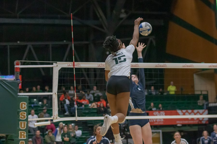Breana Runnels (15) spikes the ball over the net towards her opponents side, during the Colorado State home game against Utah State on Nov.14. CSU wins three sets to zero. (Devin Cornelius | Collegian)