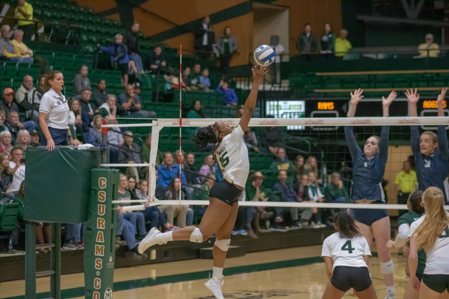 Breana Runnels (15) tips the ball over the net, during the University game against Utah State University at Moby Arena, on Nov. 14. CSU wins three sets to zero. (Devin Cornelius | Collegian)