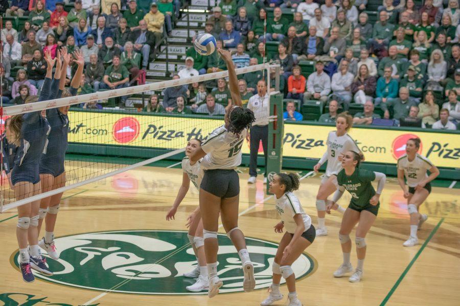 Breana Runnels (15) spikes the ball over the net towards her opponents side, during the Colorado State home game against Utah State on Nov.14. CSU wins three sets to zero. (Devin Cornelius | Collegian)