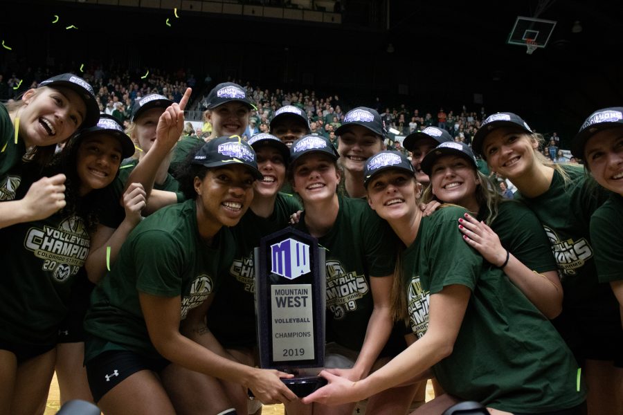 The CSU volleyball team celebrates with the Mountain West Trophy winning the Mountain West Conference. (Devin Cornelius | Collegian)