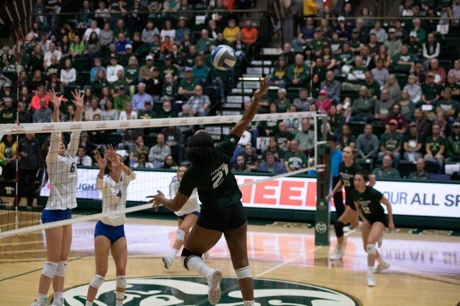 Outside hitter Jessica Jackson (21) spikes the ball towards her opponents, during the University's home game against Boise State on Nov 16. CSU wins three sets to zero. (Devin Cornelius | Collegian)