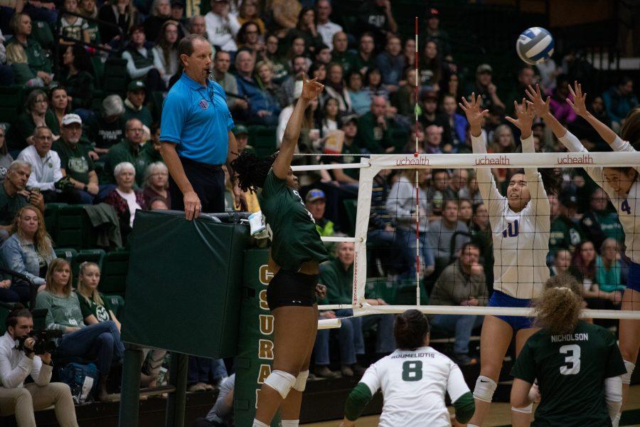 Outside hitter Breana Runnels (15) spikes the ball past defenders, during the Colorado State home game against Boise State on Nov 16. CSU wins three sets to zero. (Devin Cornelius | Collegian)
