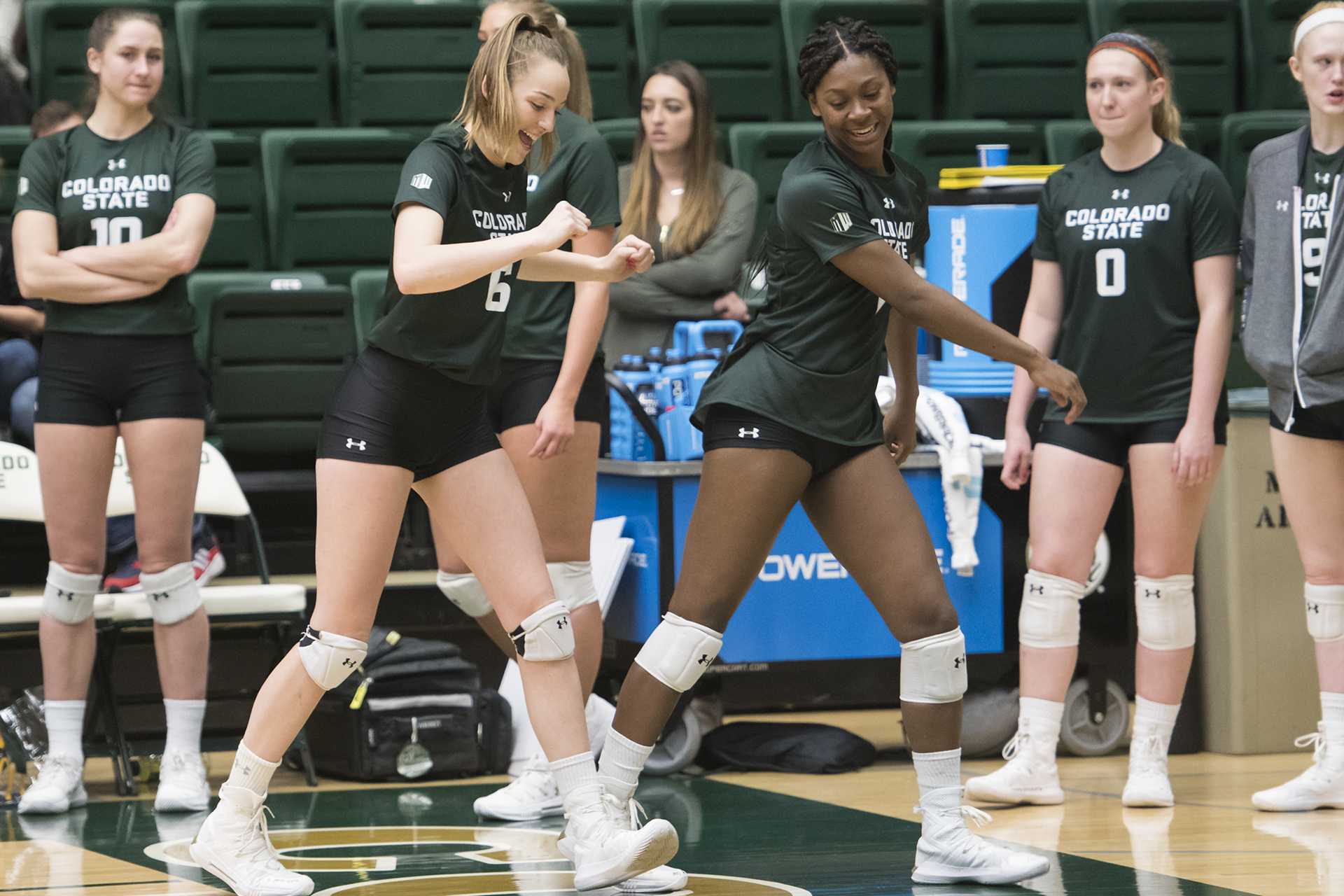 Freshmen Alana Giles and Madison Boles dance from the sideline while waiting for the first set to start.