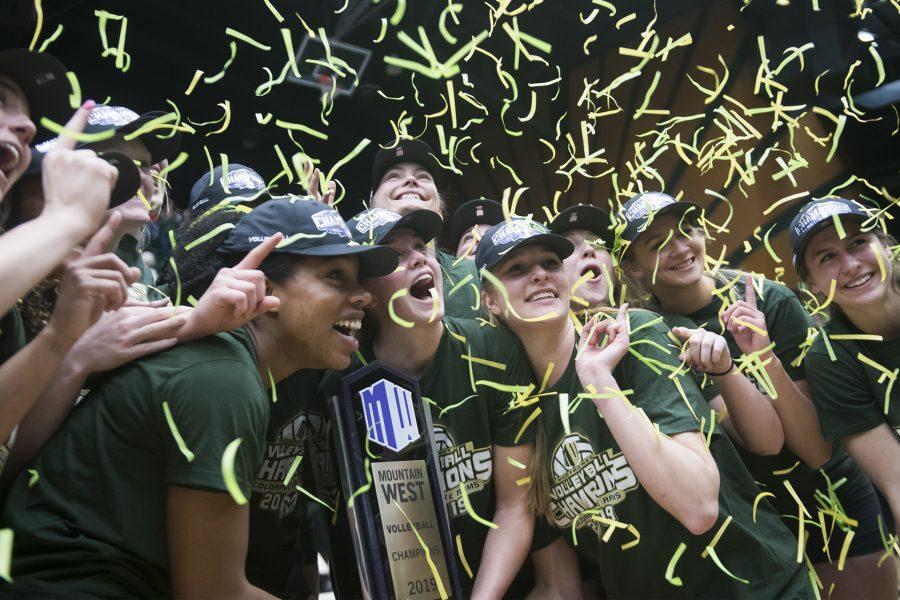 The Colorado State University women’s volleyball team holds up the 2019 Mountain West Conference Championship trophy while posing for a photo. (Lucy Morantz | The Collegian)