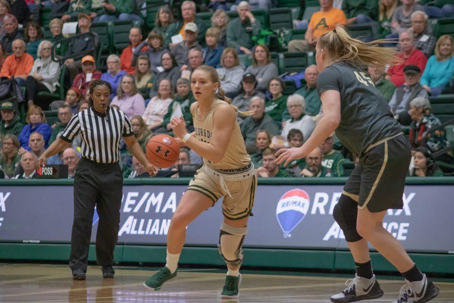 Andrea Brady (32) drives towards the basket while looking for a teammate to pass to, during the University's home game vs Colorado University on Nov. 22. CSU falls short 79-75. (Devin Cornelius | Collegian)