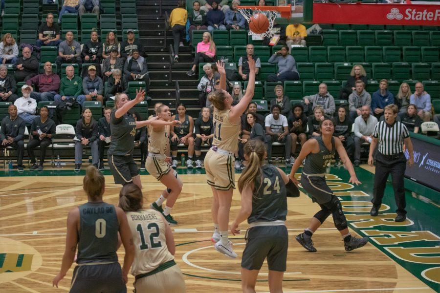Makenzie Ellis (11) jumps, shoots, and scores, during the   University's home match against Colorado University on Nov.22. CSU falls 79-75. (Devin Cornelius | Collegian)
