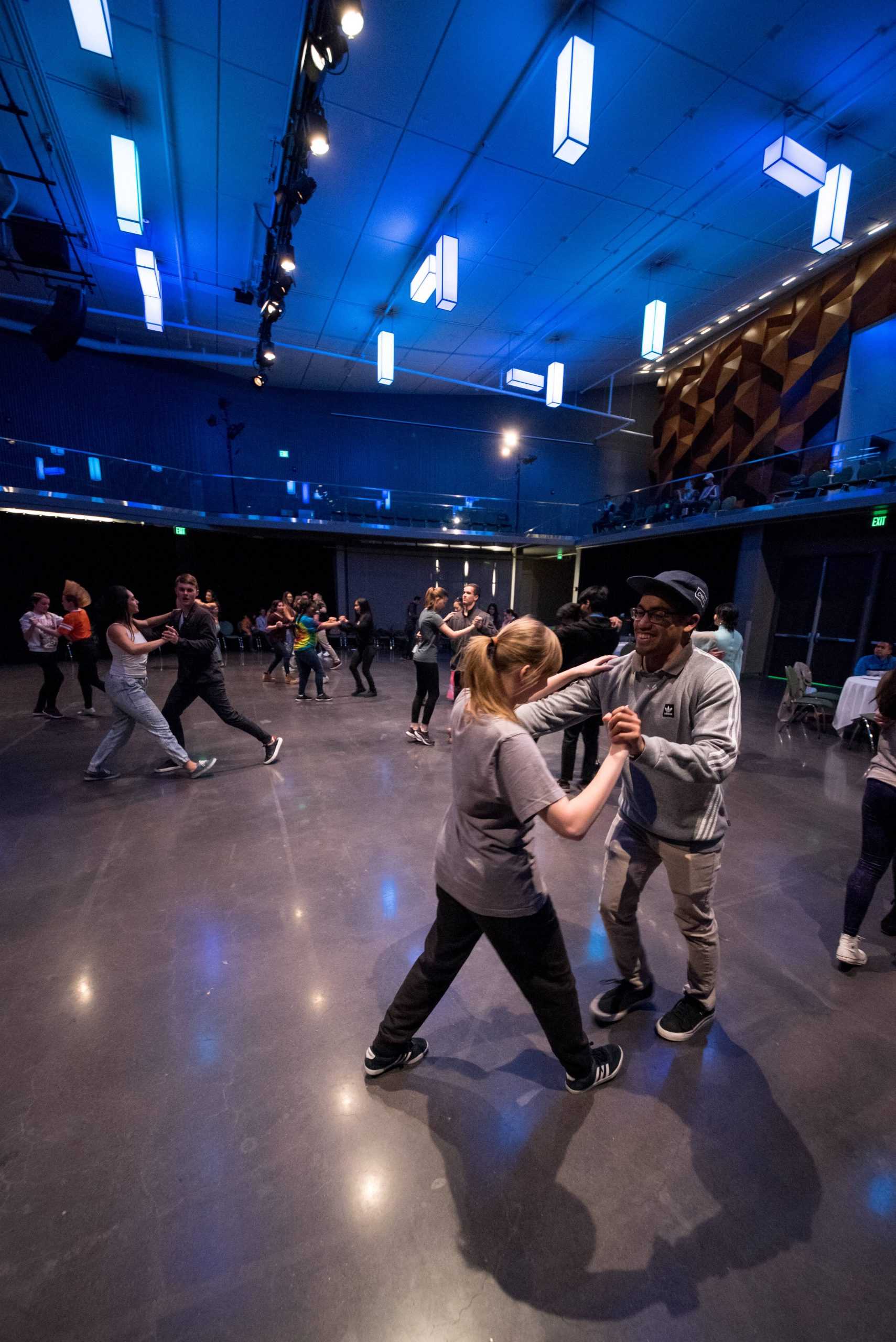 people partner dancing in a ballroom.