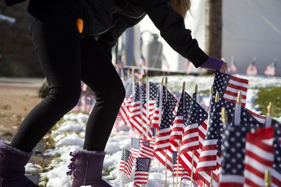 Students place flags in the plaza for Veterans Day on Nov. 11. Army Reserve Officers’ Training Corp member Abigail Waugh said, “we’re handing out the flags to memorialize all those who have fallen since 9/11” and that each flag represents a service member. (Ryan Schmidt | The Collegian)