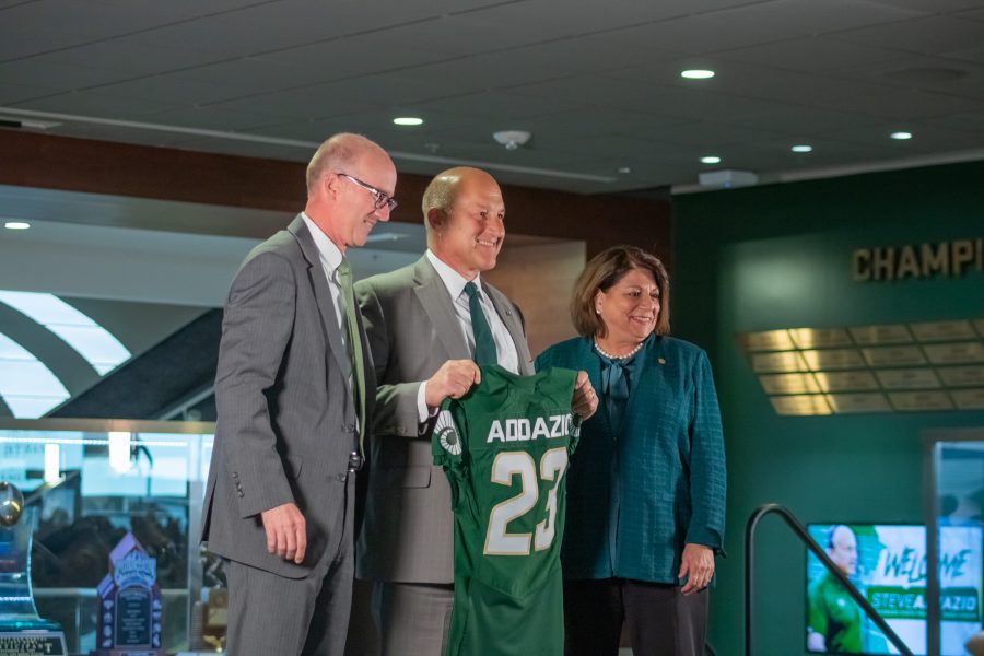 Joe Parker, Steve Addazio, and Joyce McConnell, smile for the cameras