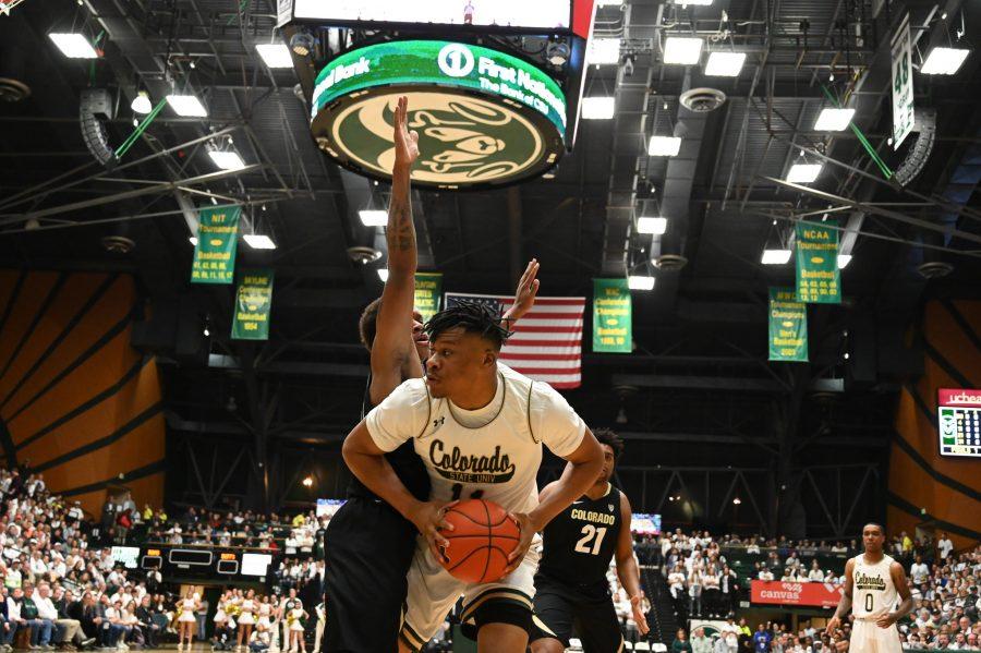 Dischon Thomas (11) fights against a University of Colorado defender to take a shot. (Luke Bourland | The Collegian) 