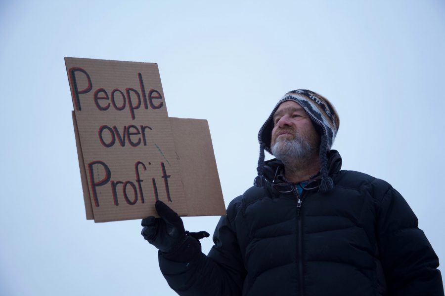 Steve Ramer protests in front of New Belgium Brewery on Dec. 14, 2019. People were protesting New Belgium’s sale to Kirin because of its questionable links to human rights violations in Myanmar. (Ryan Schmidt | The Collegian)