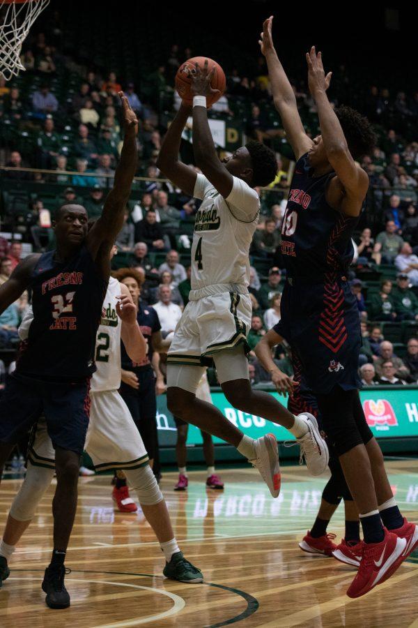 Isaiah Stevens (4) shoots while being blocked from the front and the back, during the Colorado State game vs Fresno State. CSU wins 86-68. (Devin Cornelius | Collegian)
