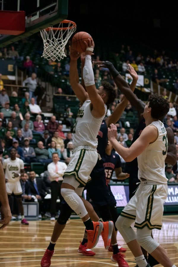 David Roddy (21) jumps up for the dunk while defenders attempt to block him, during the Colorado State game against Fresno State. CSU wins 86-68. (Devin Cornelius | Collegian)
