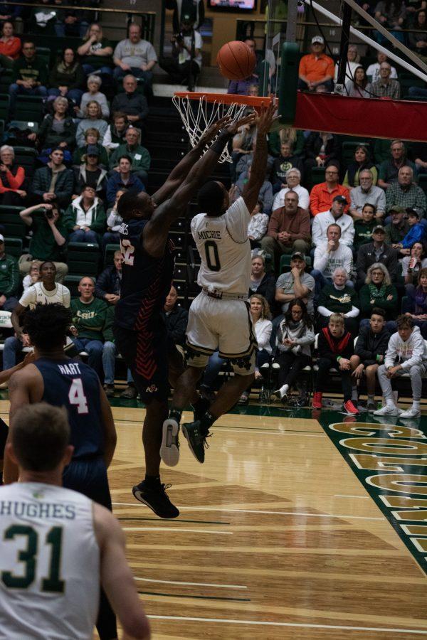 Hyron Edwards (0) shoots a layup with a defender behind him, during the Colorado State home game vs Fresno State. CSU wins 86-68. (Devin Cornelius | Collegian)