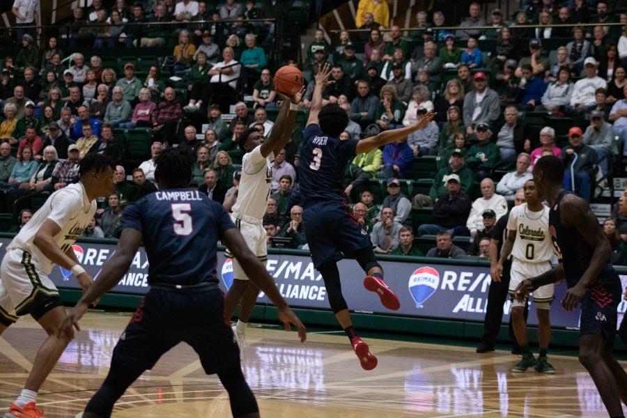 Isaiah Stevens (4) shoots from the three point line, as a defender attempts to block him, during the Colorado State home game against Fresno State. CSU wins 86-68. (Devin Cornelius | Collegian)