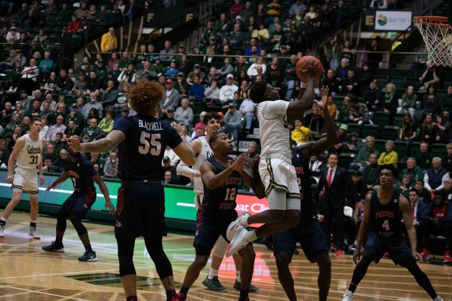 Isaiah Stevens (4) pushes past several defenders and make a layup, during the Colorado State vs Fresno State game. CSU wins 86-68. (Devin Cornelius | Collegian)