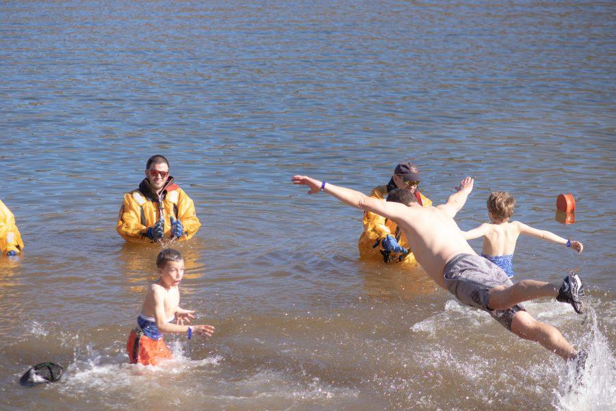A man dives into the freezing Horsetooth Reservoir waters, during the Polar Bear Run and Plunge event on Jan 20 2020. (Devin Cornelius | Collegian)