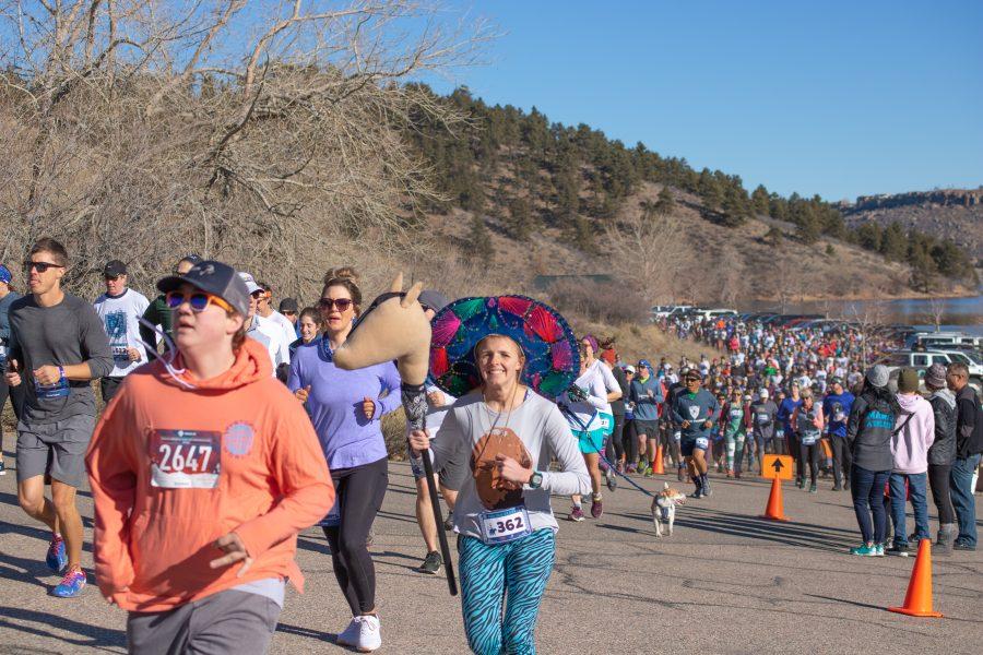 A costumed runner smiles, as the Polar Bear Run and Plunge participants run the five kilometer race on Jan 25 2020. (Devin Cornelius | Collegian)