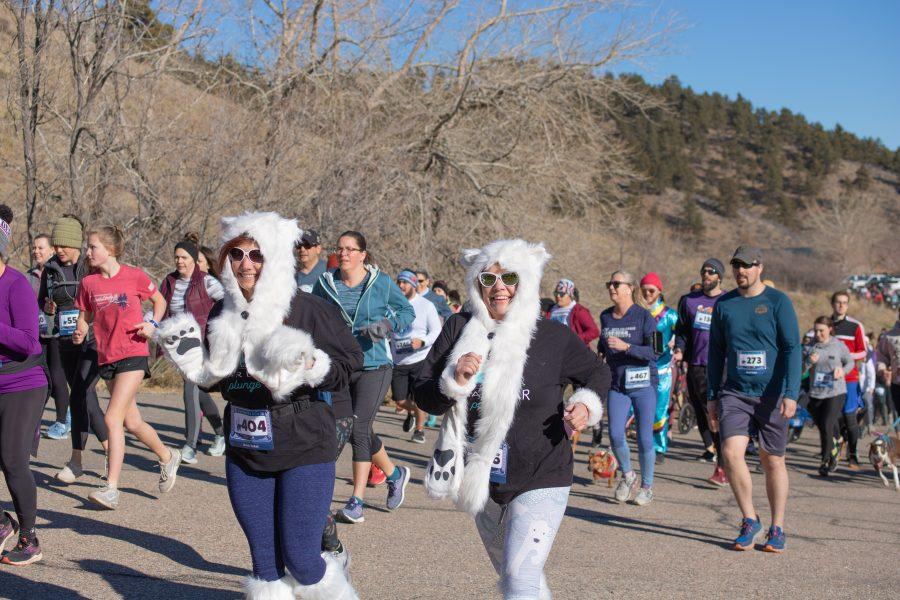 Runners smile as they begin the Polar Bear Run and Plunge five kilometer race, this year participants were encouraged to dress up as part of a costume contest. (Devin Cornelius | Collegian)